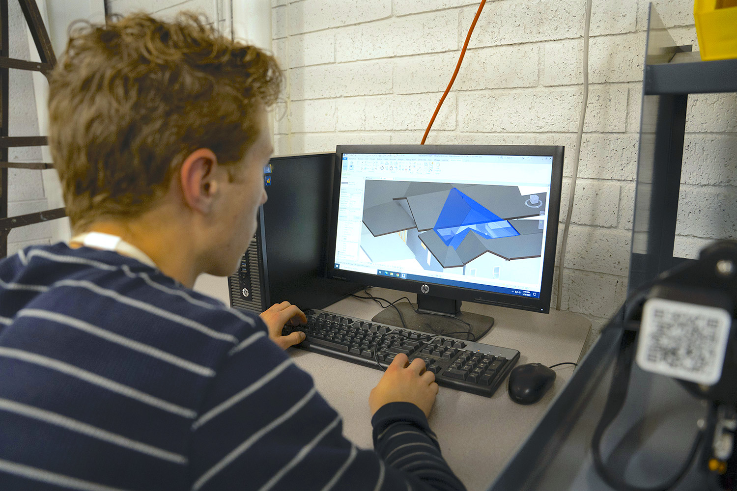 Student using CAD program to design house